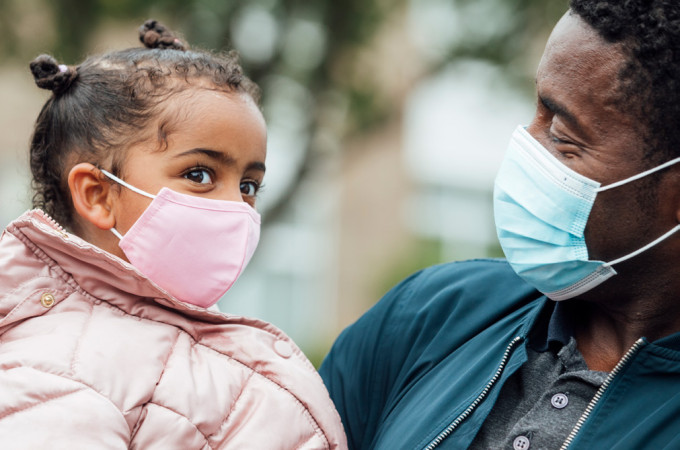 Father and daughter with masks on